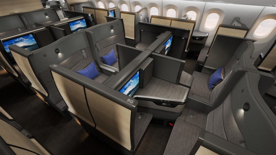 Interior view of ANA's new business class cabin featuring THE Room FX, showcasing individual suites with large screens and privacy partitions.